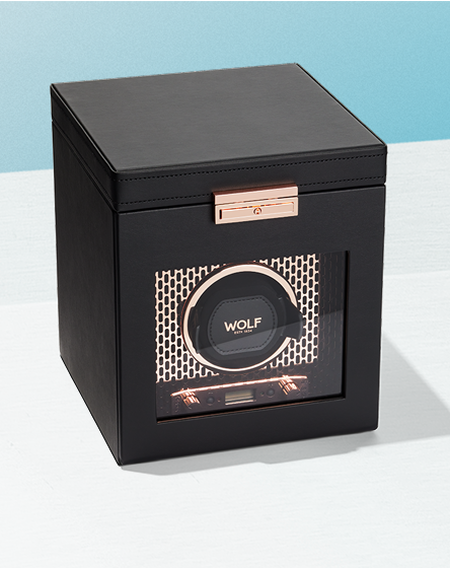 WOLF watch winder on a blueish-white background.